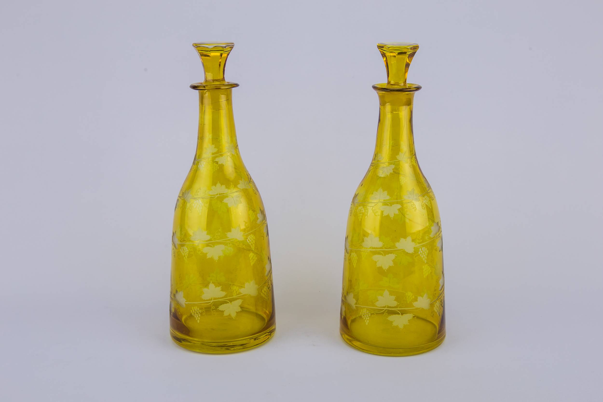 Tapered Wine Bottles — 2 yellow glass wine bottles