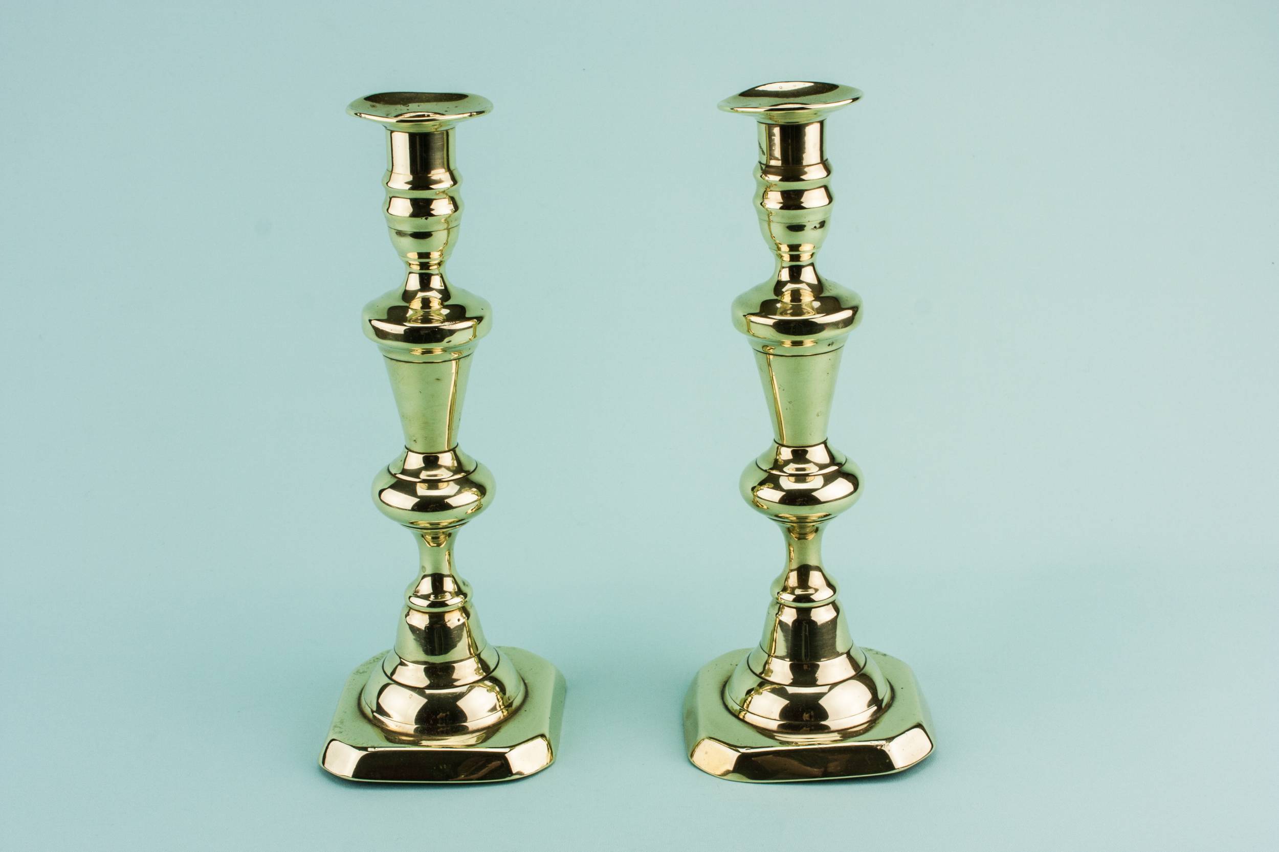 Brass Antique Bobbins — 2 brass tall candlesticks